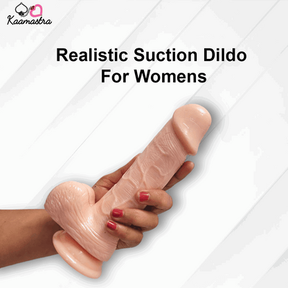Realistic suction dildo for women held by a hand on a white background with 'Kaamastra' branding.