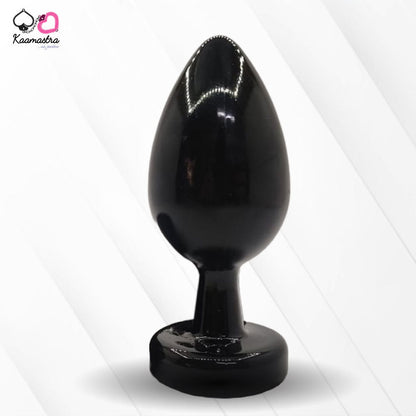 A collection of anal butt plugs in various colors, each featuring a crystal jewel at the base. The plugs are designed in a smooth, egg-shaped form.