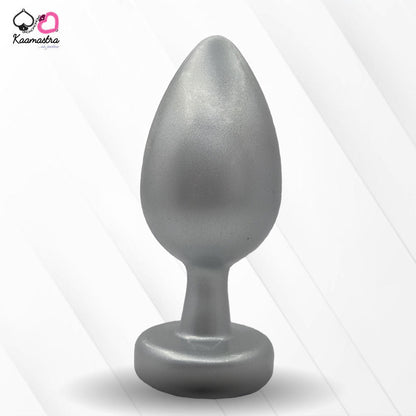 A collection of anal butt plugs in various colors, each featuring a crystal jewel at the base. The plugs are designed in a smooth, egg-shaped form.